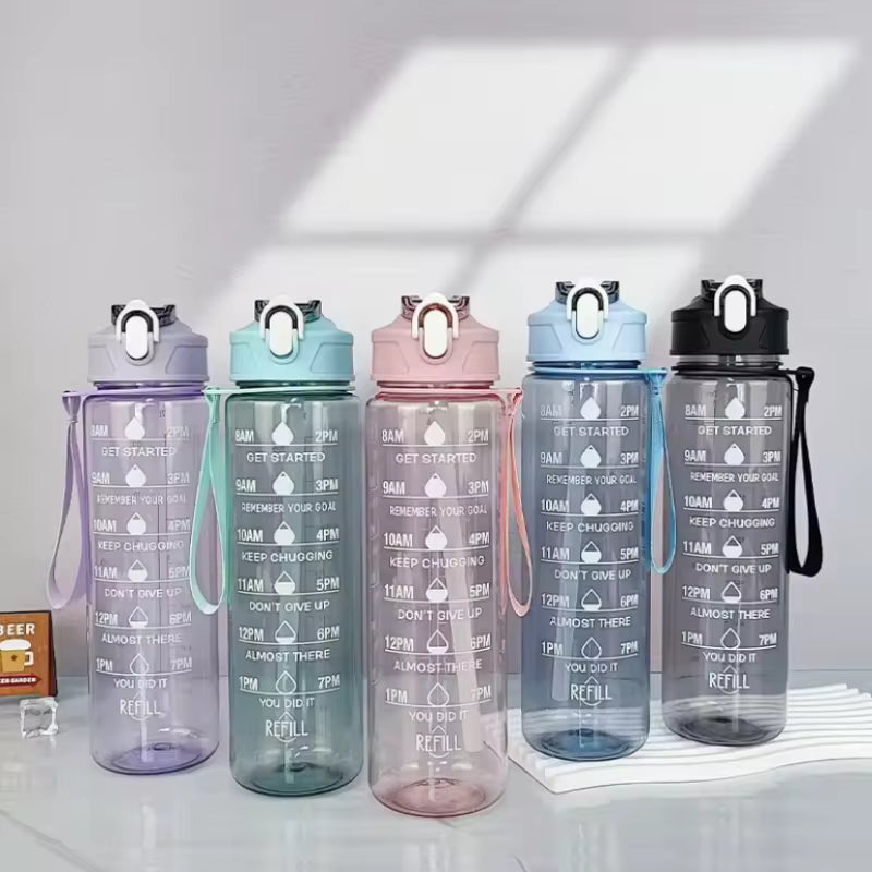 Set of five colorful water bottles with motivational text on a light background